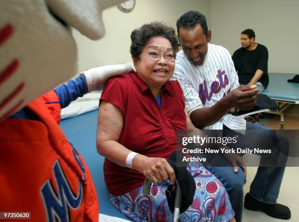 Ricarda Sanchez, who calls herself the No. 1 New York Mets' fan, shares a laugh with Mr. Met, the team mascot, and slugger Richard Hidalgo during a...