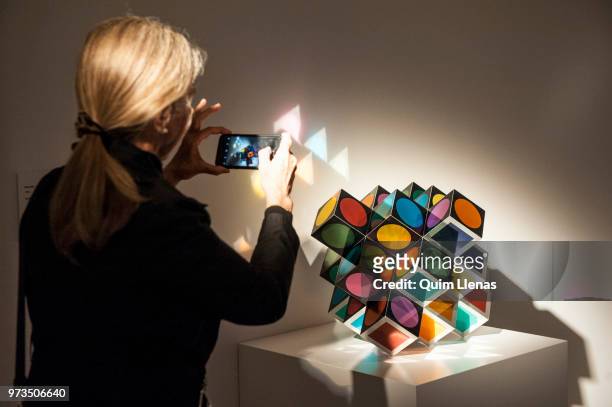 Visitor takes a photo to the multiple 'Kroa-MC' during the press opening of the retrospective exhibition of Victor Vasarely named ‘The Birth of Op...