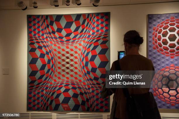 Visitor takes a photo to the tapestry 'Cheiyt-Stri-F' during the press opening of the retrospective exhibition of Victor Vasarely named ‘The Birth of...