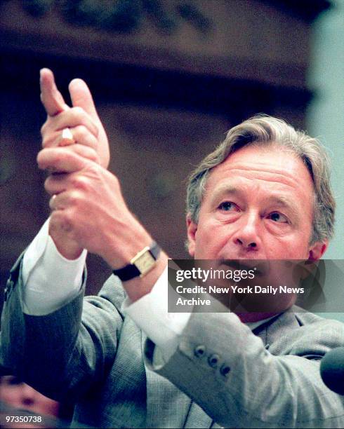 Richard DeGuerin, lawyer for deceased Branch Davidian David Koresh gestures as if firing a gun during his testimony today before the Congressional...