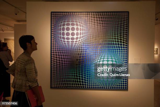 Visitor looks at the painting 'Feny' during the press opening of the retrospective exhibition of Victor Vasarely named ‘The Birth of Op Art’. Held in...