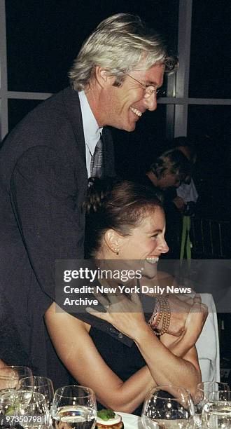 Richard Gere greets actress Julia Roberts at the Amnesty International USA Media Spotlight Awards presentations at Pier 60. Gere received a...