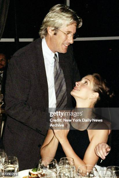 Richard Gere greets actress Julia Roberts at the Amnesty International USA Media Spotlight Awards presentations at Pier 60. Gere received a...