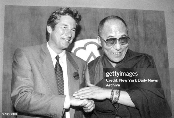 Richard Gere greets the Dalai Lama at the Mayfair Regent Hotel.