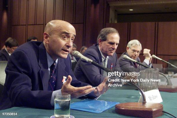 Richard Grasso, chairman of the New York Stock Exchange, testifies at a hearing of the Senate Banking Committee in Washington. Listening are Nasdaq...