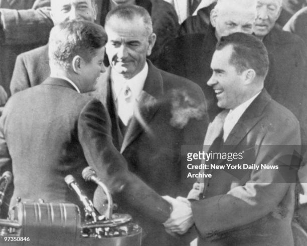 Richard Nixon congratulates President John F. Kennedy as Vice President Johnson looks on at Kennedy's inauguration in the capital. Nixon lost to...