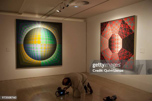 Journalist takes a photo to the painting 'Dirac' during the press opening of the retrospective exhibition of Victor Vasarely named ‘The Birth of Op...