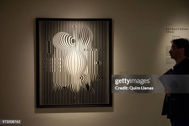 Visitor looks at the Painting 'Negative-Manipur' during the press opening of the retrospective exhibition of Victor Vasarely named ‘The Birth of Op...