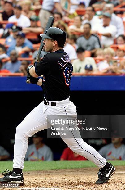 Right fielder Bubba Trammell blasts a three-run home run in his first time at bat with the New York Mets in action against the St. Louis Cardinals,...