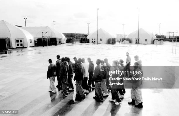 Rikers Island detainees drill in the courtyard of new "Sprungs" area where 16 to 18-year-old detainees live and attend school while awaiting trials...