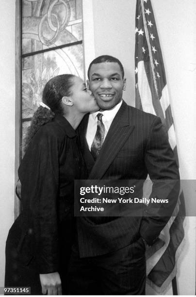 Robin Givens plants a kiss on the cheek of boxer Mike Tyson as they tie the knot at the Municipal Building in Manhattan. This is the second time the...