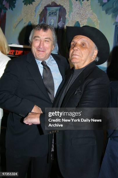 Robert De Niro receives a body blow from former boxing champ Jake LaMotta as they get together at the Ziegfeld Theater for a special screening to...