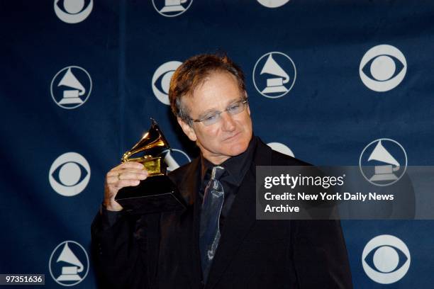 Robin Williams holds his award for Best Spoken Comedy Album backstage at the 45th annual Grammy Awards at Madison Square Garden.