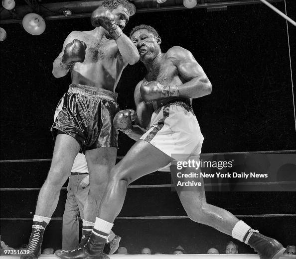 Rocky Marciano puffs' Ezzard Charles' cheeks with savage lef Rocky Marciano puffs' Ezzard Charles' cheeks with savage lef