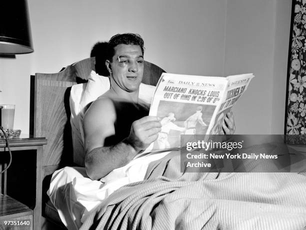 Rocky Marciano reads the Daily News at the Belmont Plaza Hotel after defeating Joe Louis.