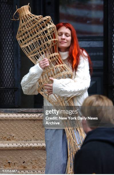 Robin Wright Penn carries a wicker dress form out of an apartment building as co-star Dallas Roberts looks on during filming of "A Home at the End of...