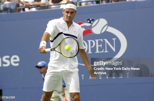 Roger Federer of Switzerland hits a return to Jose Acasuso of Argentina at the U.S. Open at Flushing Meadows-Corona Park. Federer won, 5-7, 6-3, 6-3,...