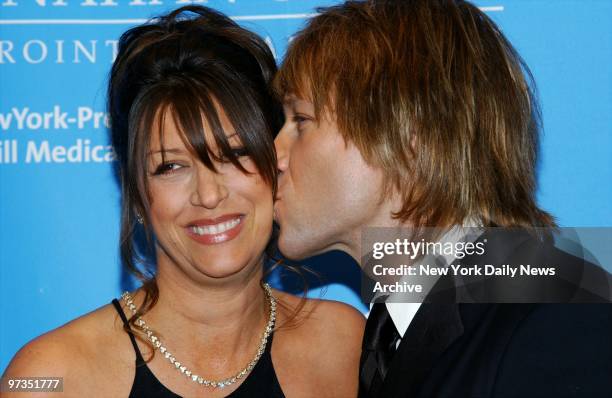 Rocker Jon Bon Jovi plants a kiss on wife Dorothea during a bash aboard the Queen Mary 2 at Pier 92 benefiting the Entertainment Industry...