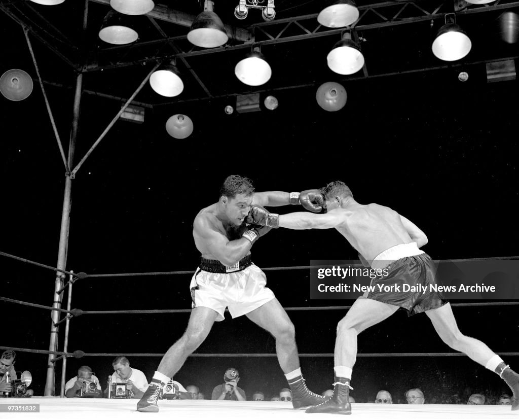 Rocky Marciano (left) trades lefts with Harry Matthews at Ya