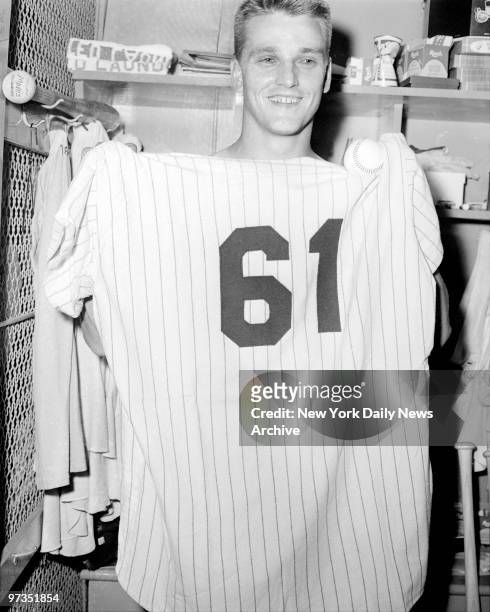 Roger Maris of the New York Yankees holds a Yankee uniform 61 after his hostoric feat against the Boston Red Sox on October 1, 1961 at Yankee Stadium...