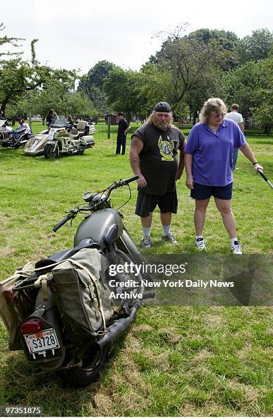 Roger and Lisa Dielmann of Lindenhurst, L.I., check out a 1941 Royal Enfield army motorcycle at the Antique Motorcycle show at the Queens County Farm...