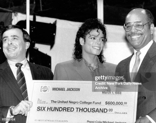Roger Enricoe, President of Pepsi, Michael Jackson present check to Christopher Edley, President of UNCF.,
