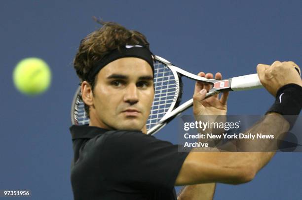 Roger Federer of Switzerland keeps his eye on the ball as he prepares to hit a backhand shot during his fourth-round 2007 U.S. Open match against...