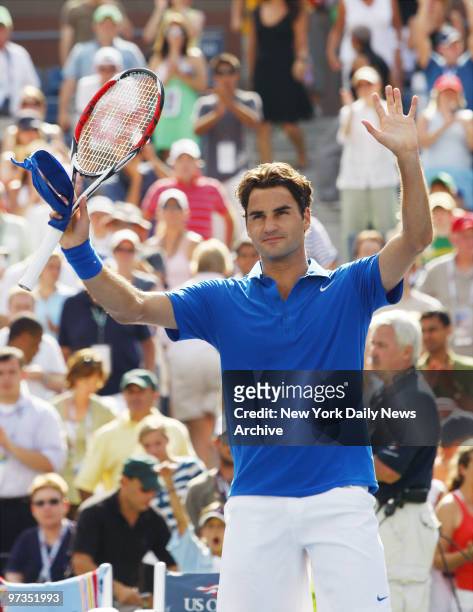Roger Federer of Switzerland waves to fans after defeating Scoville Jenkins of the United States during a match in Arthur Ashe Stadium at the Billie...