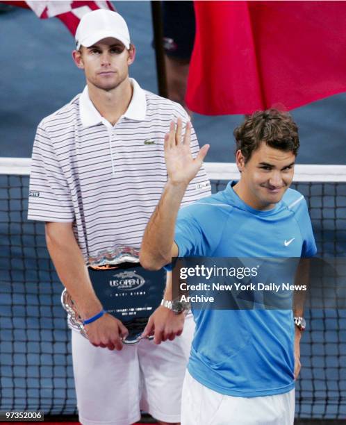 Roger Federer waves to fans during the trophy ceremony after his 6-2, 4-6, 7-5, 6-1 defeat over Andy Roddick in the 2006 U.S. Open men's finals at...