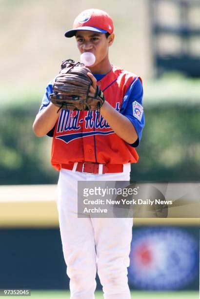 Rolando Paulino All-Stars' Luilly Vinas blows a bubble as he pitches against team from Davenport, Iowa, in the second game of the 2001 Little League...
