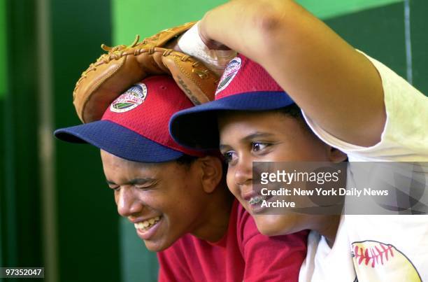 Rolando Paulino All-Stars' pitcher Danny Almonte and catcher Francisco Pe??a clown around before the game at Howard J. Lamade Stadium in...