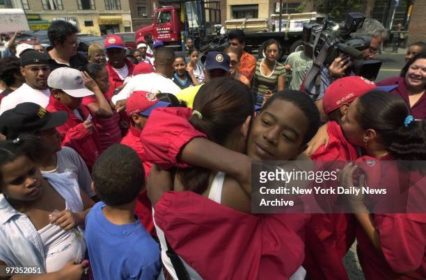Rolando Paulino All-Stars' reserve catcher Christopher Geronimo gets a big hug from his mom as the Baby Bombers are welcomed home at E. Tremont and...