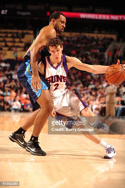 Goran Dragic of the Phoenix Suns drives against Malik Allen of the Denver Nuggets in an NBA Game played on March 1, 2010 at U.S. Airways Center in...