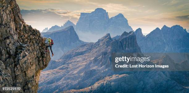 climber on rocky wall, dolomites, cortina d'ampezzo, veneto, italy - adrenalin stock-fotos und bilder