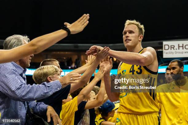 Luke Sikma of ALBA Berlin celebrates after winning the fourth play-off game of the German Basketball Bundesliga finals at Mercedes-Benz Arena on June...