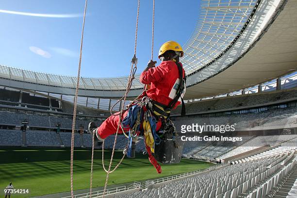 Construction worker uses ropes and a harness inside Greenpoint stadium in Cape Town during preparation work, ahead of the FIFA 2010 World Cup, March...