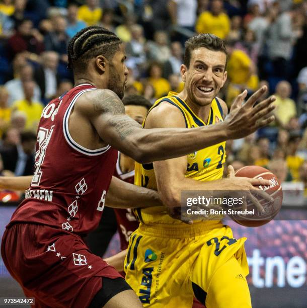 Spencer Butterfield of ALBA Berlin competes with Devin Booker Bayern Muenchen during the fourth play-off game of the German Basketball Bundesliga...