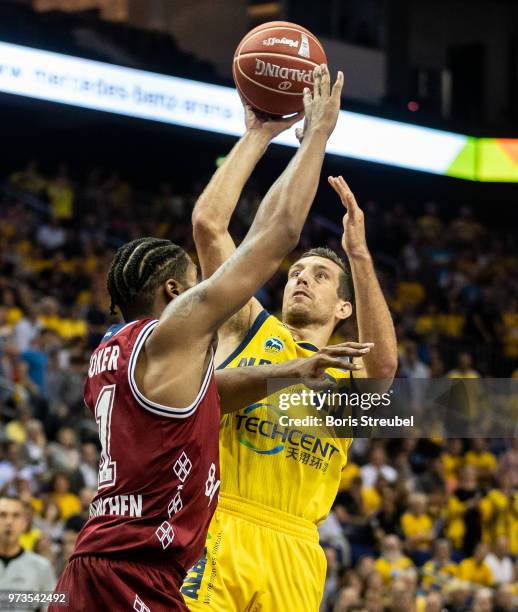 Spencer Butterfield of ALBA Berlin competes with Devin Booker Bayern Muenchen during the fourth play-off game of the German Basketball Bundesliga...
