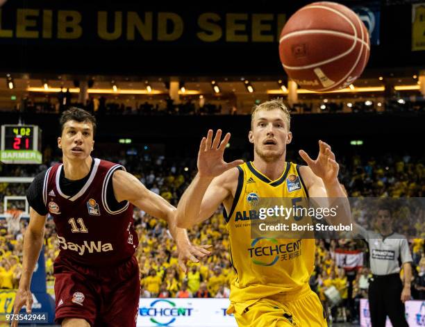 Niels Giffey of ALBA Berlin competes with Vladimir Lucic of Bayern Muenchen during the fourth play-off game of the German Basketball Bundesliga...