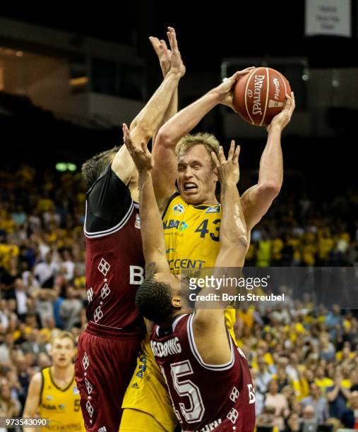 Luke Sikma of ALBA Berlin competes with Reggie Redding of Bayern Muenchen during the fourth play-off game of the German Basketball Bundesliga finals...
