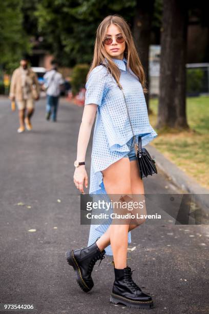 Xenia Tchoumitcheva, wearing light blue shirt, jeans shorts, Bulgari bag and combat boots, is seen during the 94th Pitti Immagine Uomo at Fortezza Da...