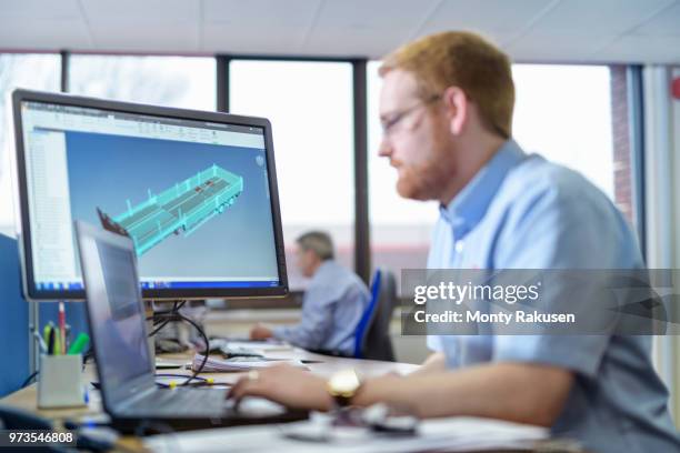 designers with cad drawings in trailer factory - cad designer stockfoto's en -beelden