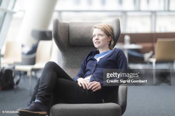 woman taking break in office - sigrid gombert stock-fotos und bilder