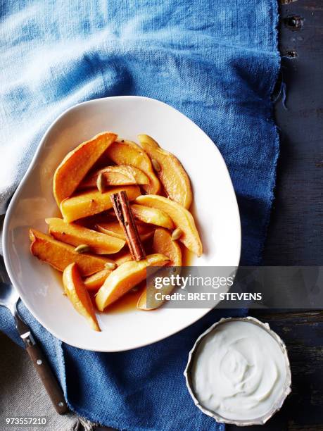 still life with bowl of quince cooked in rooibos tea and red wine, overhead view - kvitten bildbanksfoton och bilder