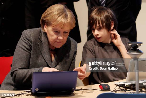 German Chancellor Angela Merkel gets instruction from Richard at the Microsoft Digital Classroom at the CeBIT Technology Fair on March 2, 2010 in...