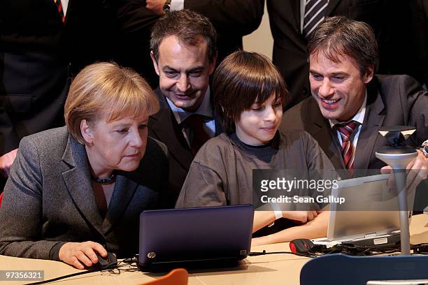 German Chancellor Angela Merkel, Spanish Prime Minister Jose Luis Rodriguez Zapatero and Microsoft Germany head Achim Berg ges instruction from...