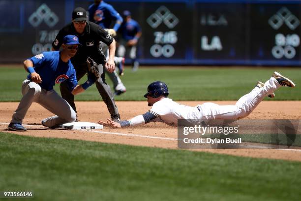 Hernan Perez of the Milwaukee Brewers steals third base past Tommy La Stella of the Chicago Cubs in the second inning at Miller Park on May 27, 2018...