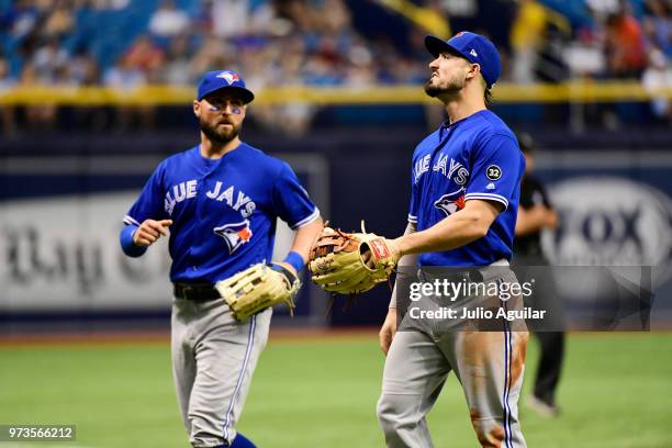 Kevin Pillar and Randal Grichuk of the Toronto Blue Jays run off the field after the top of the seventh inning against the Tampa Bay Rays on June 13,...