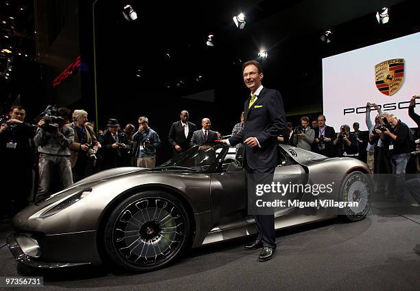 Michael Macht, chief executive officer of Porsche SE, poses next to the Porsche 918 Spyder concept car during the first press day at the 80th Geneva...