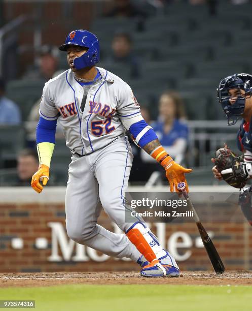Left fielder Yoenis Cespedes of the New York Mets swings during the game against the Atlanta Braves at SunTrust Park on April 21, 2018 in Atlanta,...